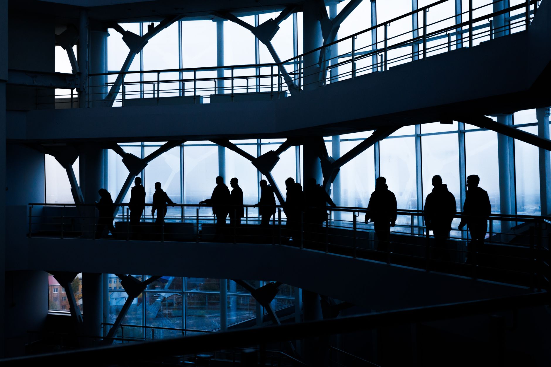 Silhouettes of people walking in a modern architectural building with large windows. — Anabolic Steroids: Unveiling the Mecha