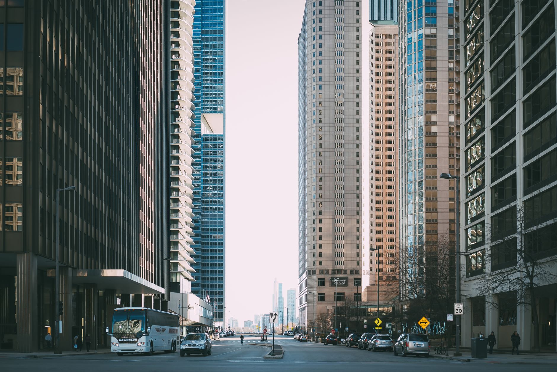 Vibrant city street scene with tall skyscrapers and city life full of cars and pedestrians. — How Dr Michael Lebow Designs Tr