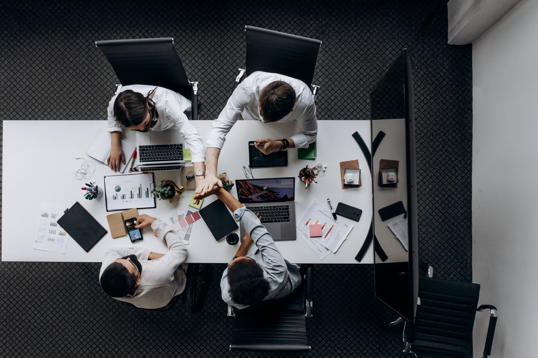 High angle view of colleagues collaborating around a conference table in a modern office setting. — Lone Star Protection: A G