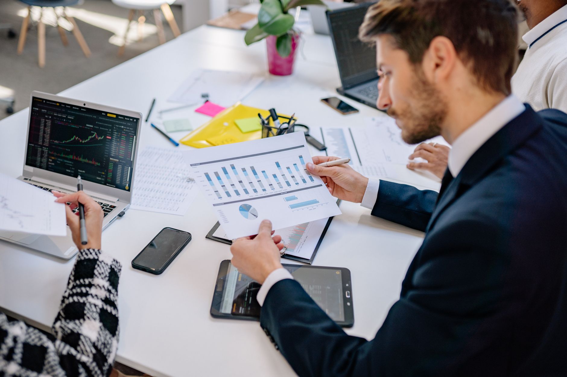 Business team reviewing graphs and data in an office setting. — Modern Professional: Streamlined Resume Template