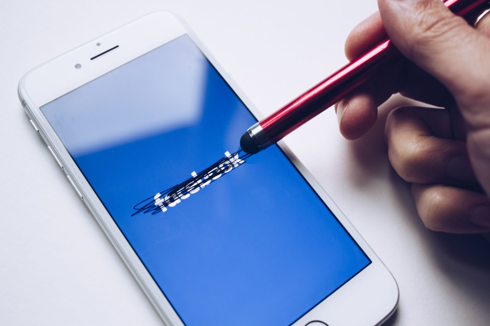 Close-up of a smartphone with a stylus crossing out text on its screen. — Propel Your Profile: Buy Real Instagram Followers T