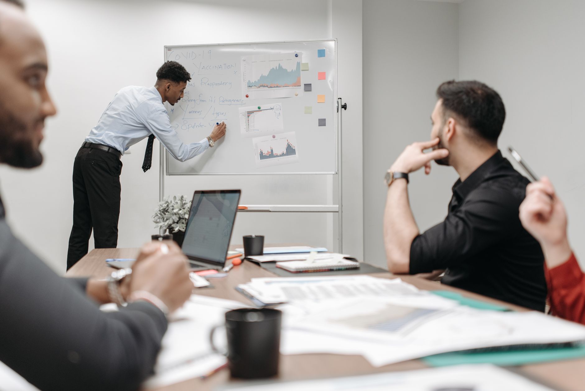 Colleagues in a business meeting discussing data and strategies at the office. — Relx Electronic Cigarette: A Comprehensive R