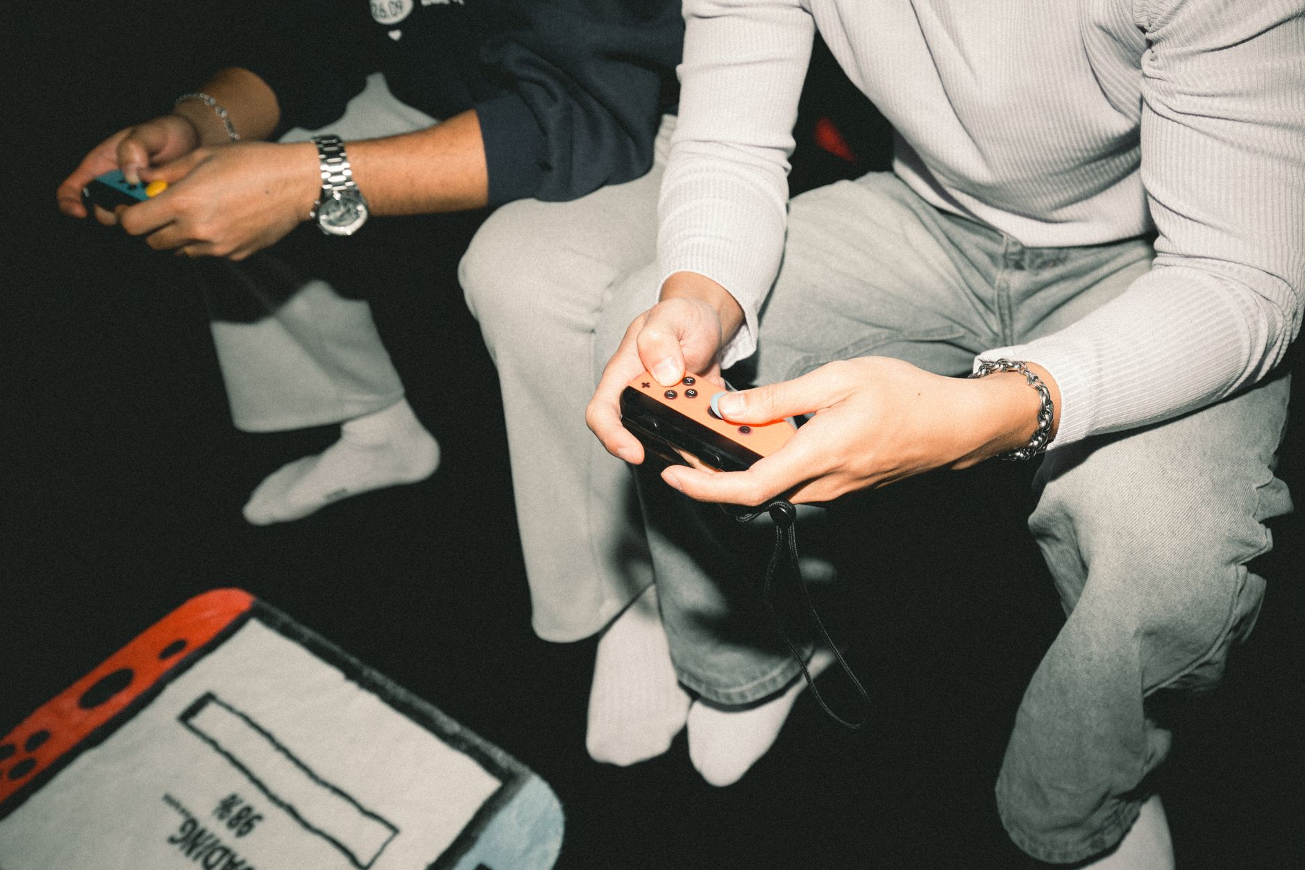 Two adults enjoying a video game session together, focused on controllers. — Tales from the Table: Legendary Roulette Strateg